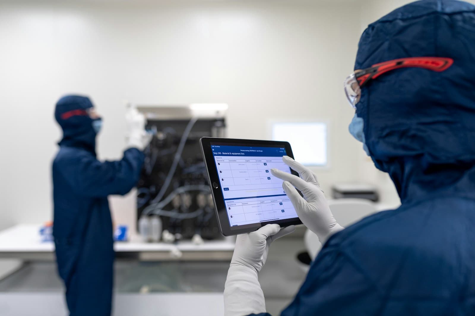 Researchers in a laboratory reviewing data together at a computer workstation